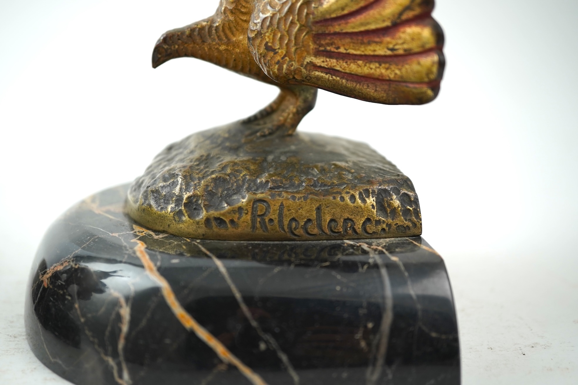 A pair of bronze peacock bookends, with remains of coloured pigments, marble plinths, signed R. Leclerc, 20cm